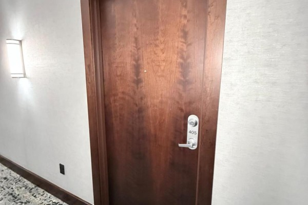 Apartment entrance door with a wood grain finish and the number 405. - 405 - 2470 Prince Michael Drive, Oakville