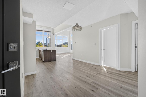 View from entryway into open living space with island and city view. - #405 10227 115 St Nw, Edmonton