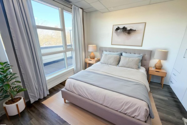 Spacious balcony with tiled flooring and glass railing, overlooking the neighborhood. - #405 11503 76 Av Nw, Edmonton