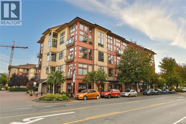 Exterior view of a multi-story apartment building with balconies and large windows on a sunny day. - 405 829 Goldstream Ave, Langford