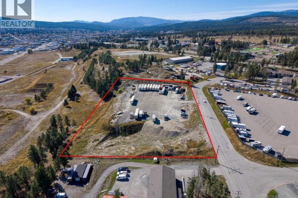 Aerial view showcasing a large industrial lot with semi-trailers and some stored equipment. - 405 Industrial F Road, Cranbrook