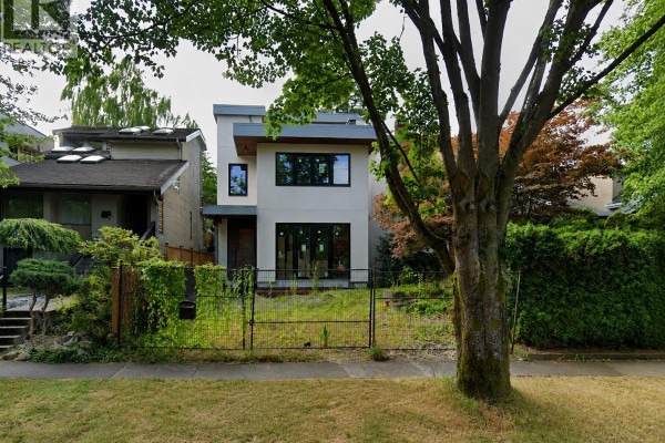 Modern house with white and gray facade and large windows on a grassy lot. - 4054 W 17th Avenue, Vancouver