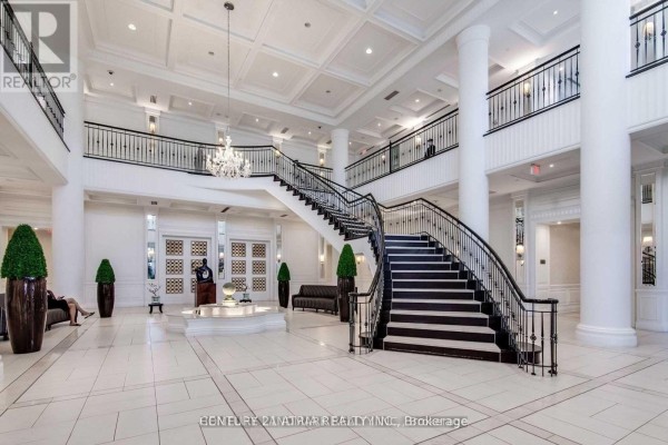 Grand hotel-like lobby with a large white tile floor, grand staircase, and chandelier. - 406 - 15 Greenview Avenue, Toronto