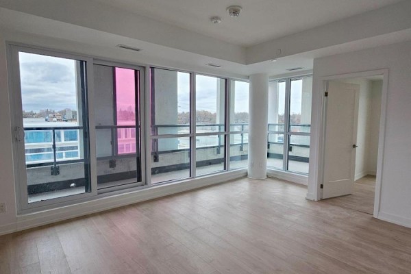 Living area with light wood floors, floor-to-ceiling windows, and access to a balcony. - 406 - 181 Sheppard Avenue E, Toronto