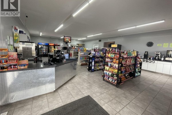 Mechanical room with multiple pumps, gauges, and a wooden ladder against the wall. - 406 - 410 Railway Avenue, Eston