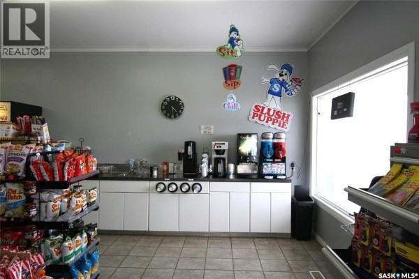 Interior of a convenience store showing a coffee station, slushie machines, and shelves of snacks. - 406 - 410 Railway Avenue, Eston