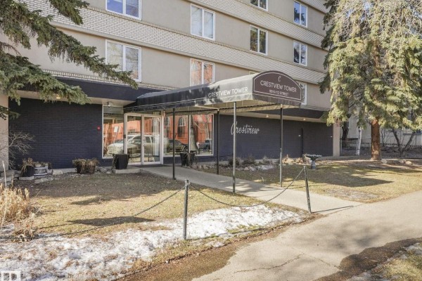 Covered entrance to Crestview Tower with glass doors and signage. - #406 9816 112 St Nw, Edmonton