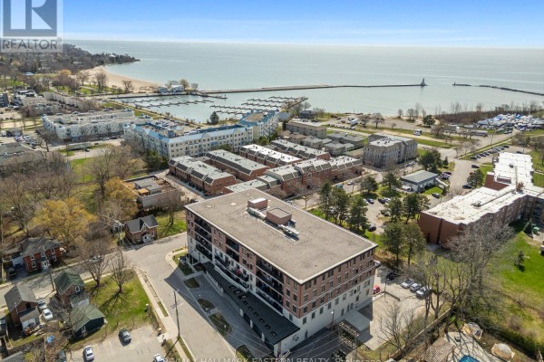 Aerial view of an apartment building and marina on the shores of Lake Ontario. - #407 - 135 Orr Street, Cobourg