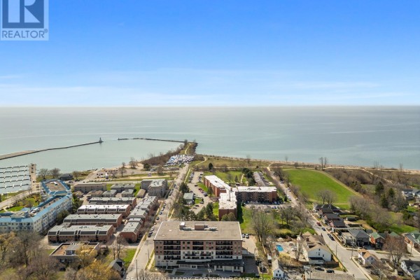 Aerial view of the Lake Ontario waterfront with a distant lighthouse and marina. - #407 - 135 Orr Street, Cobourg