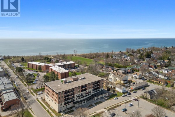 Aerial view of an apartment building with Lake Ontario visible in the distance. - #407 - 135 Orr Street, Cobourg