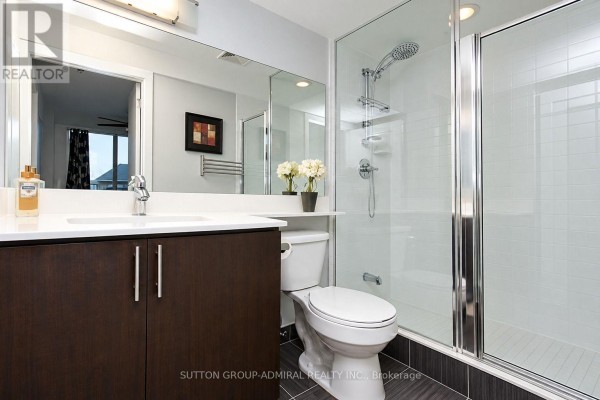 Large wood-floored community room with coffered ceiling, seating area, and tables. - 407 - 30 North Park Road, Vaughan