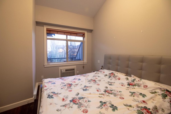 Gym with treadmills, elliptical, and weight machines, featuring mirrored walls. - 407 8328 207a Street, Langley