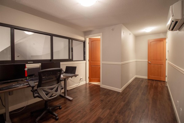 Bathroom with a clawfoot tub, toilet, and double vanity with dark counters. - 407 8328 207a Street, Langley