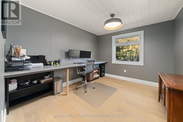 Home office with dual monitors, desk, and rolling chair - 407 County Road 4 Prince Edward County