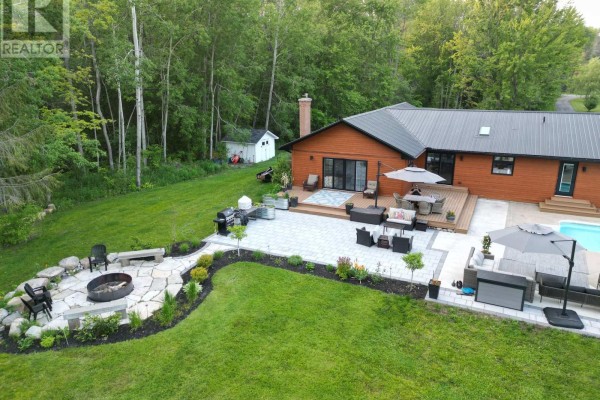 Backyard with pool, deck, patio, fire pit, grill - 407 County Road 4 Prince Edward County