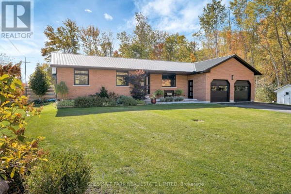 Brick ranch home with metal roof, two-car garage, and shed - 407 County Road 4 Prince Edward County