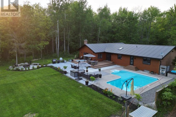 Backyard oasis with pool, hot tub, deck, and seating area - 407 County Road 4 Prince Edward County