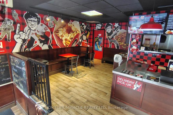 Seating area with booth benches, red tables, and checkered wall accents inside the restaurant. - 407 Dalhousie Street, Ottawa