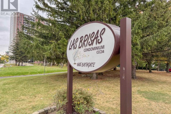 Circular sign with building name "LAS BRISAS CONDOMINIUM" and address "665 BATHGATE". - 408 - 665 Bathgate Drive, Ottawa