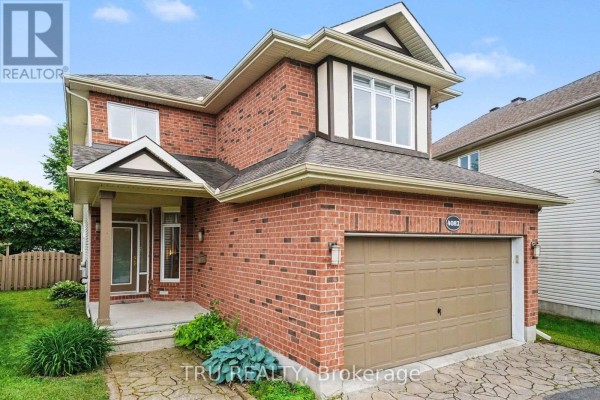 Front exterior of a brick house with a covered entrance and garage. - 4082 Otter Tail Crescent, Ottawa