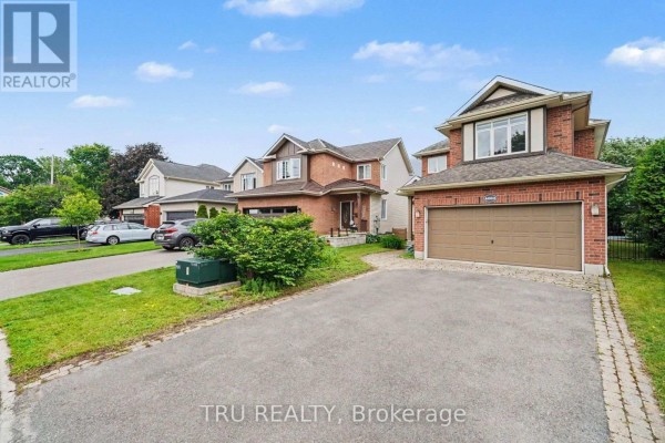 Street view of a brick house with an attached garage and driveway. - 4082 Otter Tail Crescent, Ottawa
