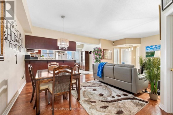 Living area with sofa, dining space, and open layout with natural light - 409 - 4006 Kilmer Drive, Burlington