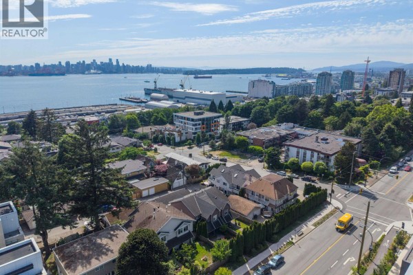Aerial view of residential neighborhood with water and city skyline in distance. - 409-411 417-419 E 3rd Street, North Vancouver