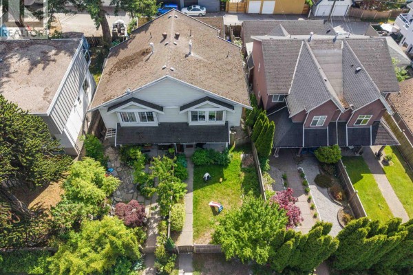 Aerial view of duplex with front yards, trees, and neighboring townhouses. - 409-411 417-419 E 3rd Street, North Vancouver