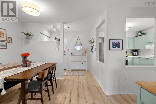 Dining area with a dark wood table and chairs, overlooking the entryway and kitchen. - 409 93 Kearney Lake Road, Kearney Lake