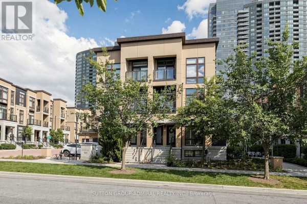 Townhouse complex with surrounding trees and modern buildings in the background. - 41 - 19 Eldora Avenue, Toronto