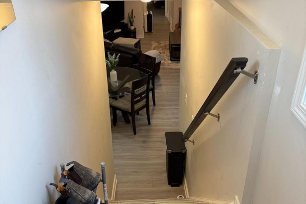 View looking down a hallway towards a living and dining area with wood floors. - 41 - 3200 Singleton Avenue, London South