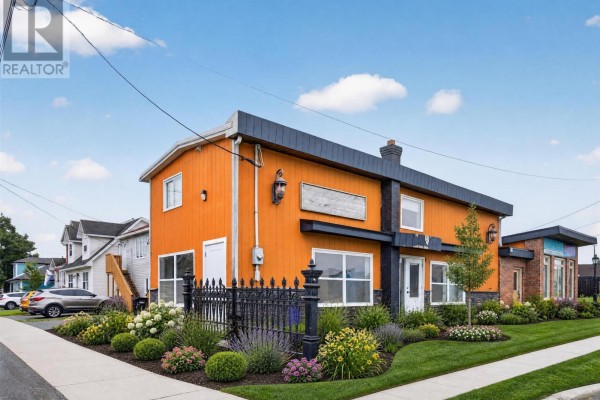 Exterior of the property during the day with manicured landscaping and a bright orange facade. - 41 Cashin Avenue, St John S