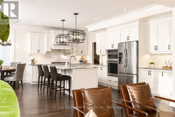 Cozy living room with built-in shelves, modern fireplace, and comfortable seating arrangement. - 41 Creanona Boulevard, Hamilton