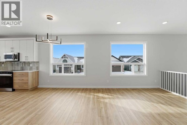 Kitchen area with stainless steel appliances, light wood cabinets, and a view of the backyard. - 41 Emmett Crescent, Red Deer