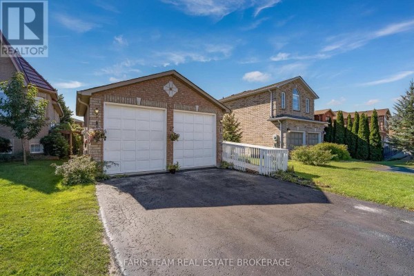 Side view of the property showcasing the brick exterior, garage, and neighboring houses. - 41 Irene Drive, Barrie