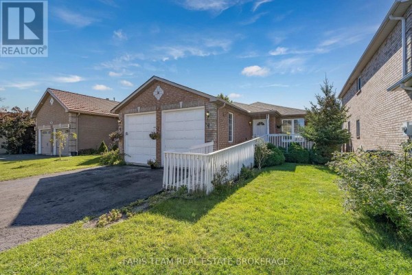 Front view of the house with a white railing leading to the entrance and a green lawn. - 41 Irene Drive, Barrie
