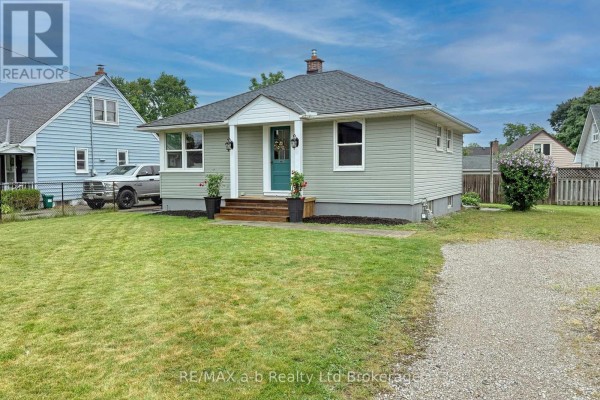 Side exterior view of a light green bungalow with a driveway and lawn. - 41 Kensington Street, Woodstock