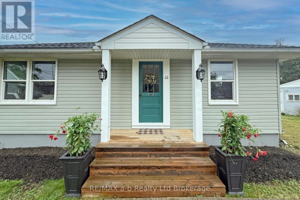 Close-up of the front porch with teal door, wooden steps, and planter boxes. - 41 Kensington Street, Woodstock