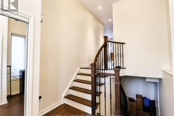 Spacious foyer with chandelier, hardwood flooring, and staircase. - 41 Mansard Drive, Richmond Hill