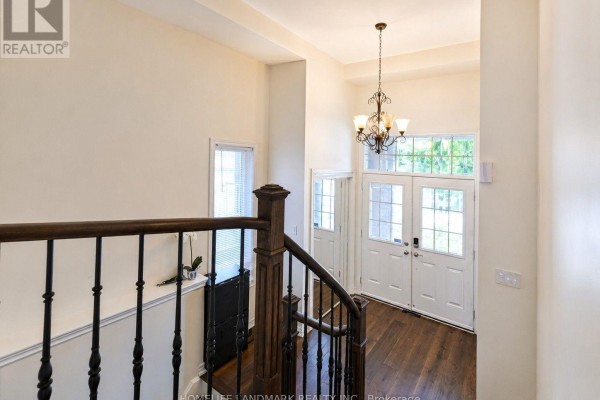 Staircase view with hardwood floors and natural light from windows. - 41 Mansard Drive, Richmond Hill