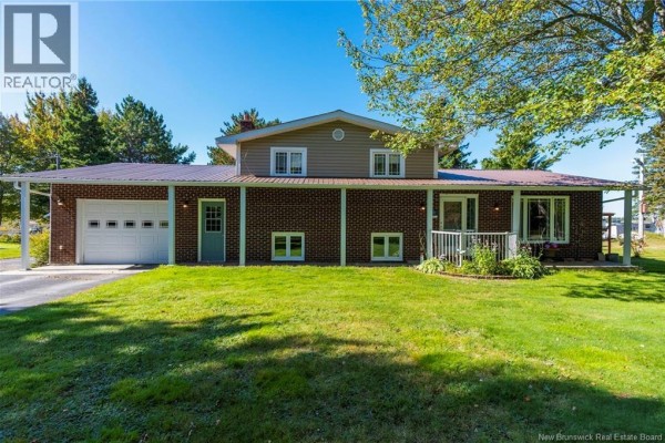 Front view of the residential house with brick and vinyl siding, and a covered porch. - 41 Manuel, Baie Sainte Anne