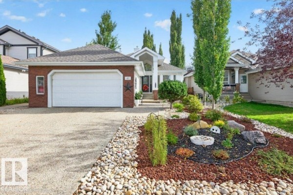 Exterior of a brick and siding house with a paved driveway and walkway. - 41 North Ridge Dr, St  Albert