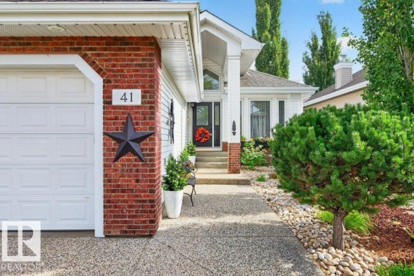 Close-up of the front door entrance with brick detailing and a decorative star. - 41 North Ridge Dr, St  Albert