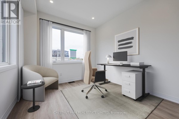 Home office with a large window, desk, ergonomic chair, and neutral decor. - 41 Robert Eaton Avenue, Markham
