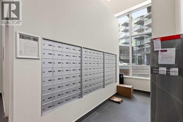Wall of silver mailboxes with many compartments inside the building's common area. - 410, 10 Brentwood Common Nw, Calgary