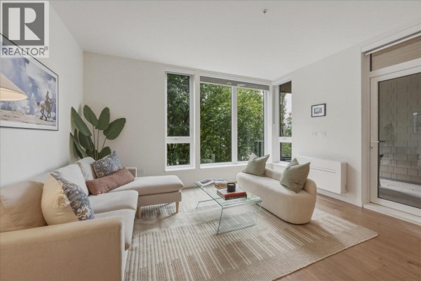 Interior common area with a staircase, seating areas, and people working. - 410 1500 Scott Crescent, Squamish
