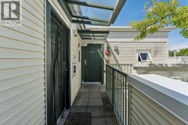 Exterior entryway to unit 410 with a green door and metal railings. - 410 3727 W 10th Avenue, Vancouver
