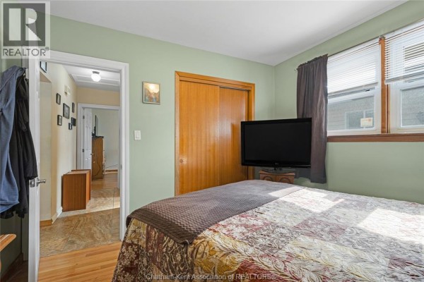 Bedroom with wooden bed frame and dresser - 410 Mcnaughton Avenue East Chatham