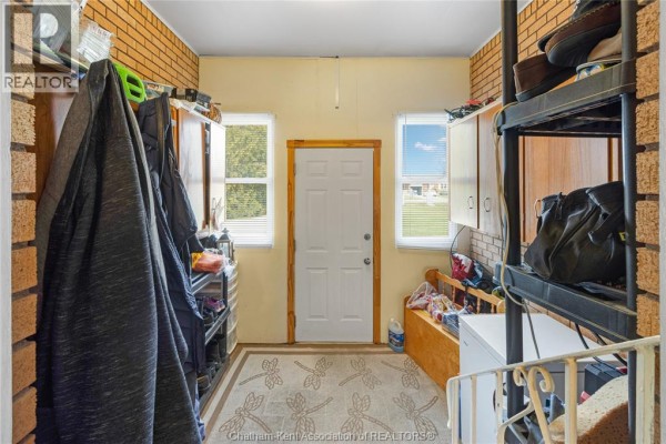 Brick house with attached garage and paved driveway - 410 Mcnaughton Avenue East Chatham