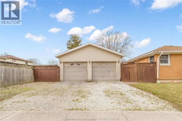 Fenced backyard with shed and grass lawn - 410 Mcnaughton Avenue East Chatham